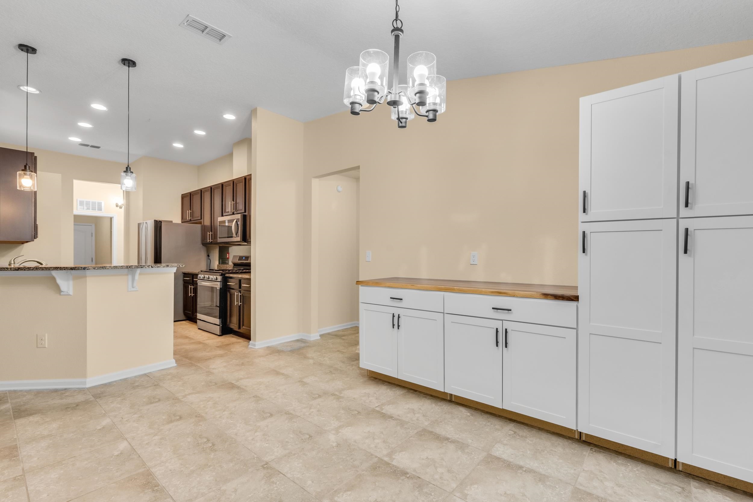 228 Fox Water Trail St. Augustine, FL 32086 - Photo 29 of 50 a view of a kitchen with stainless steel appliances granite countertop a refrigerator and a sink