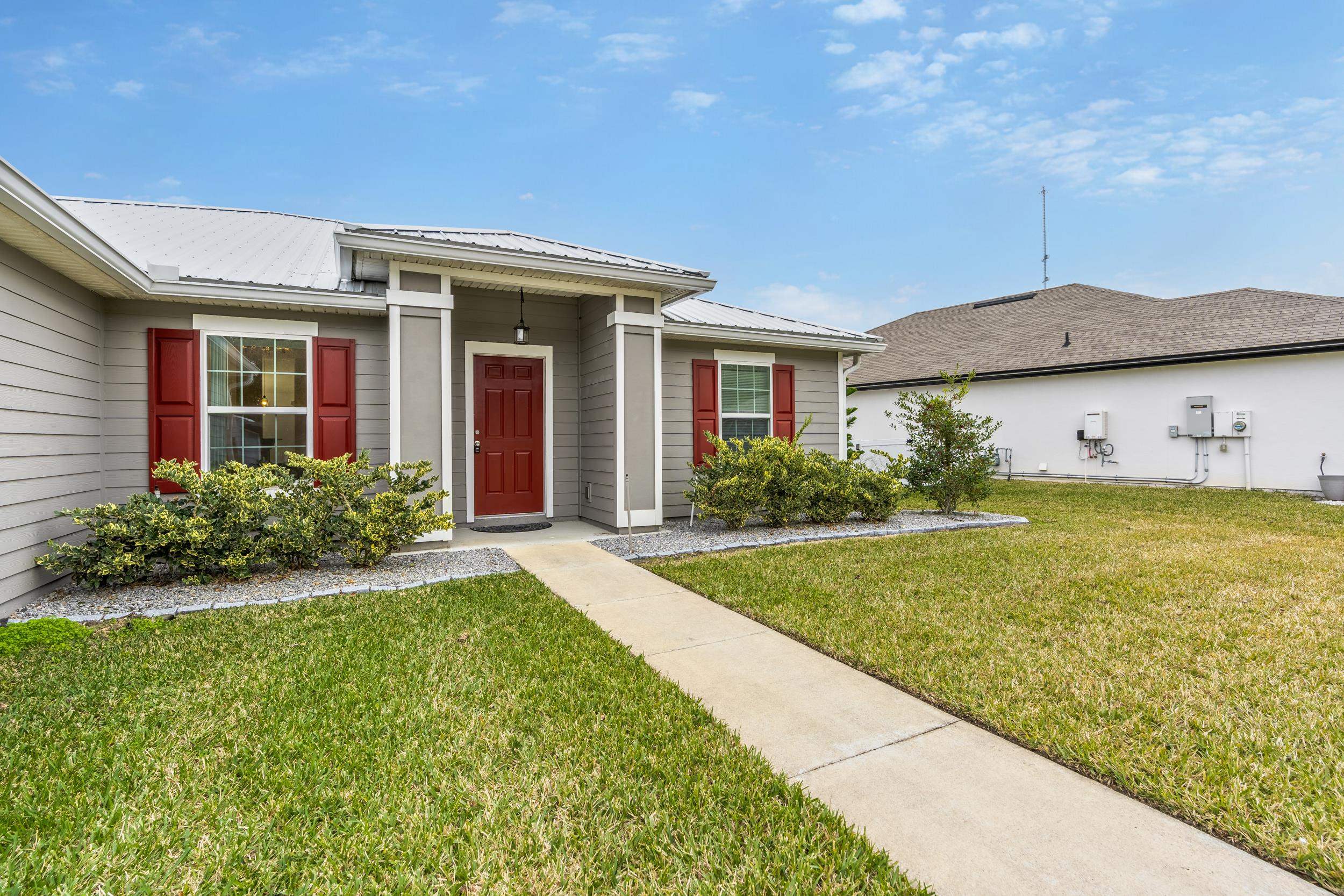 228 Fox Water Trail St. Augustine, FL 32086 - Photo 3 of 50 a front view of a house with garden