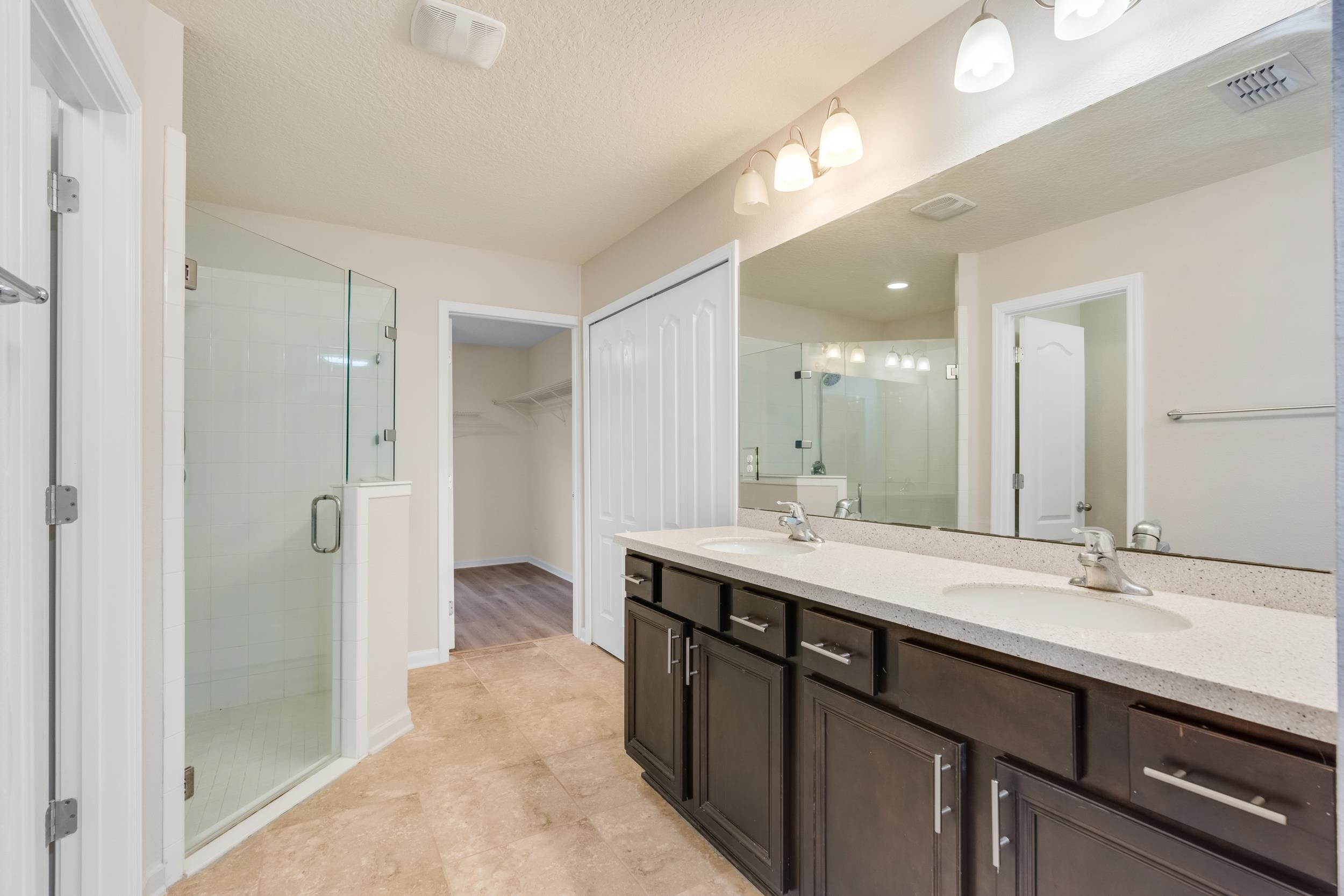 228 Fox Water Trail St. Augustine, FL 32086 - Photo 35 of 50 a bathroom with a double vanity sink mirror and shower