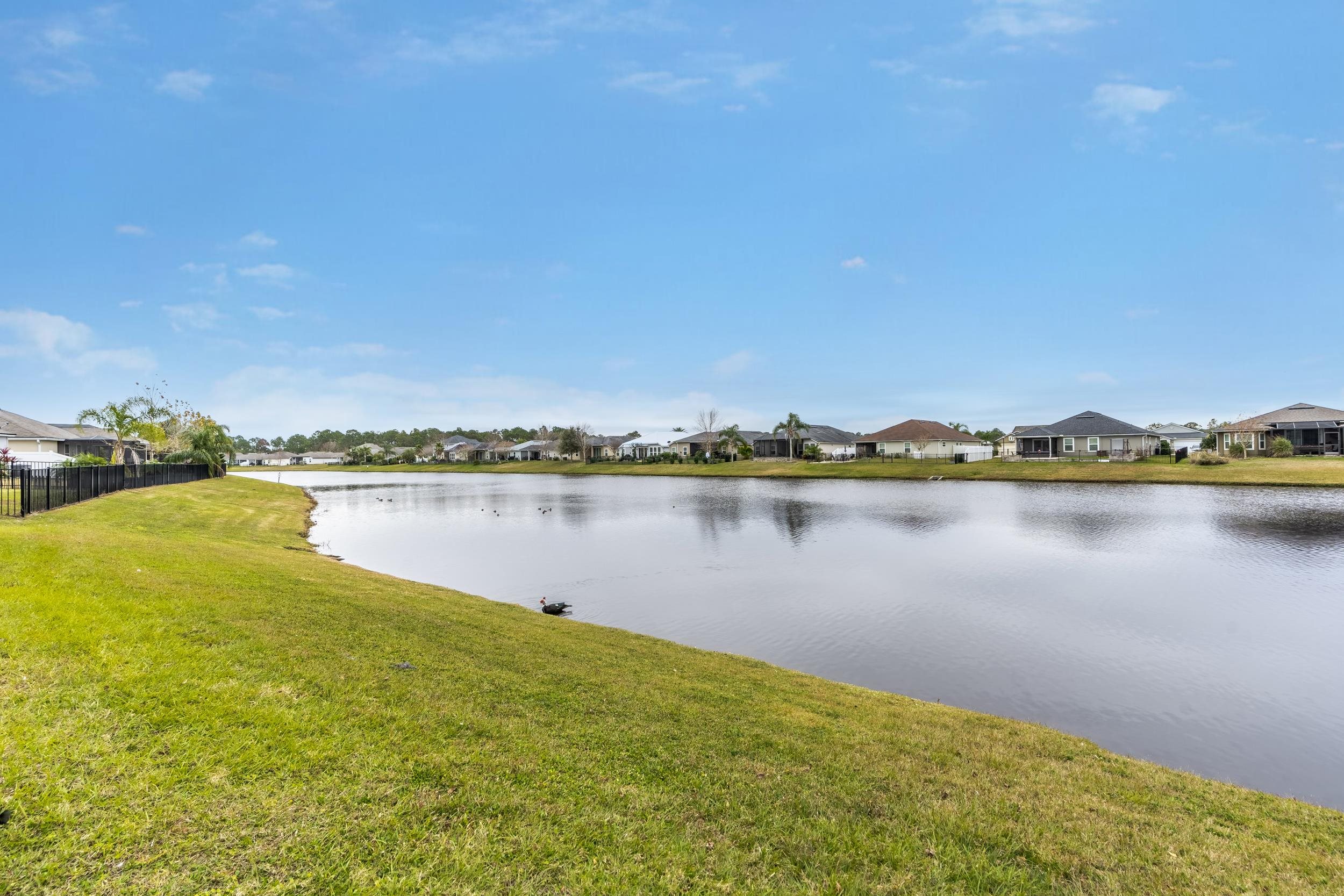 228 Fox Water Trail St. Augustine, FL 32086 - Photo 44 of 50 a view of a lake with houses in the background