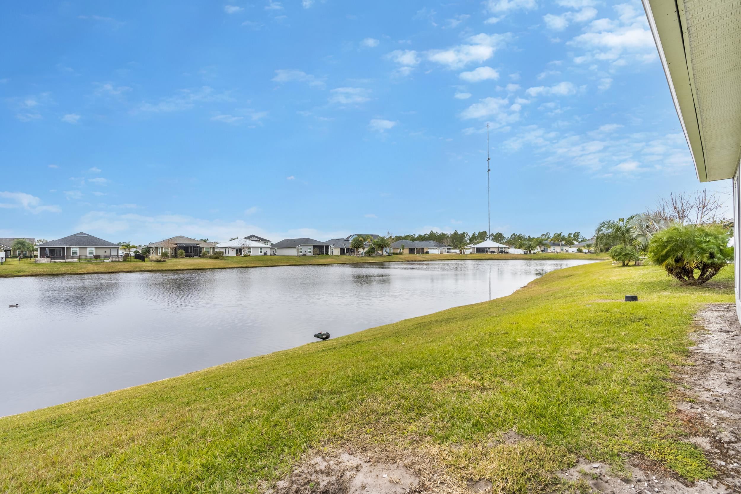 228 Fox Water Trail St. Augustine, FL 32086 - Photo 45 of 50 a view of a lake with a big yard