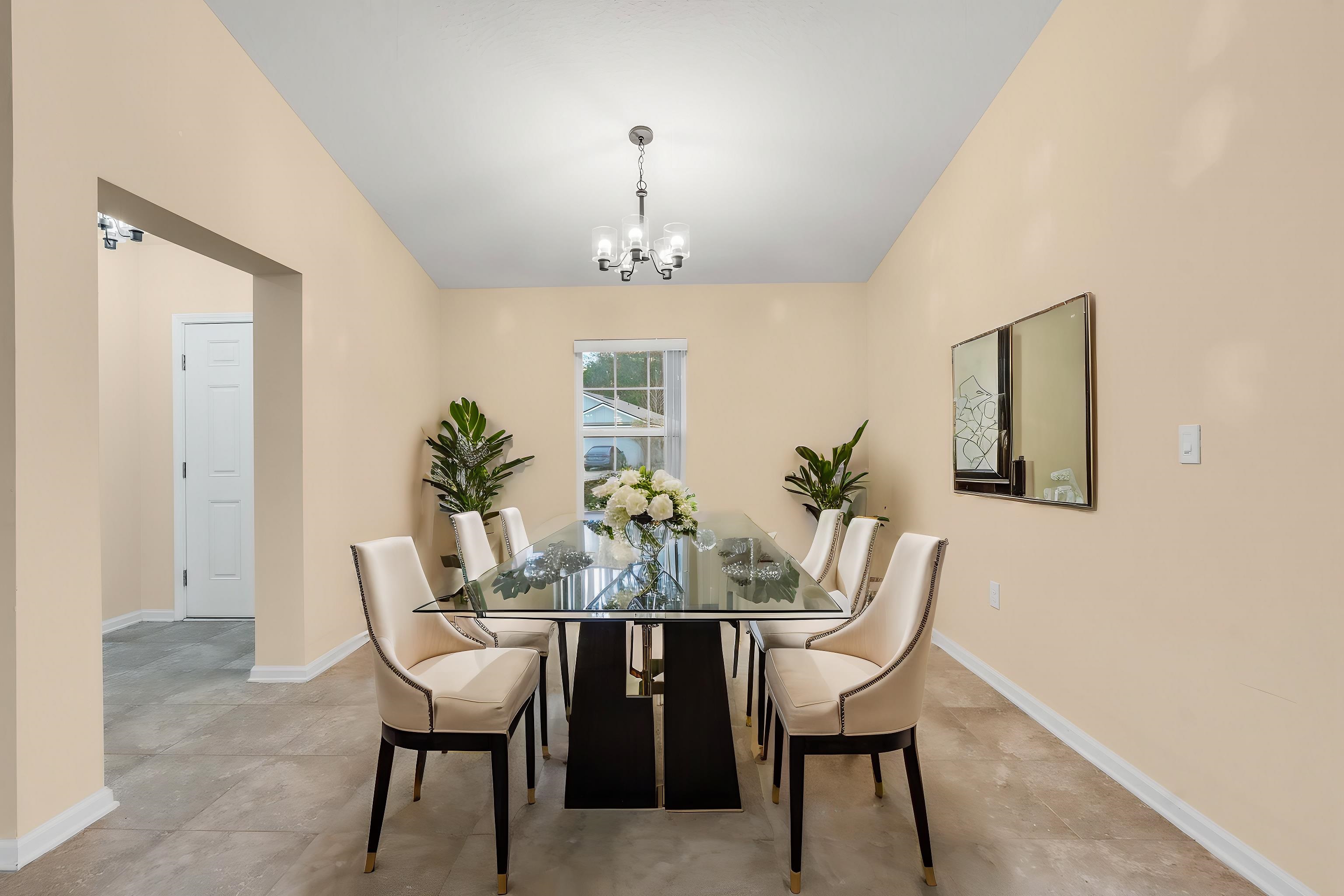 228 Fox Water Trail St. Augustine, FL 32086 - Photo 9 of 50 a view of a dining room with furniture and chandelier