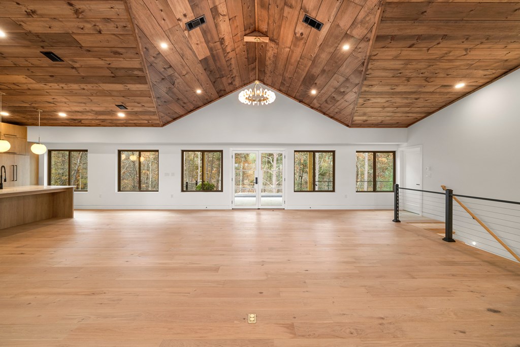1713 Old Northcutt Road Ellijay, GA 30536 - Photo 13 of 45 a view of an empty room with wooden floor and a window