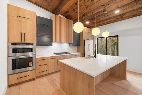 a kitchen with a stove a sink and a refrigerator