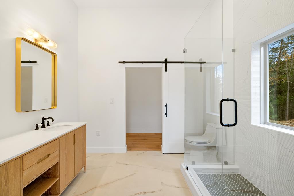 1713 Old Northcutt Road Ellijay, GA 30536 - Photo 36 of 45 a bathroom with a tub sink and mirror