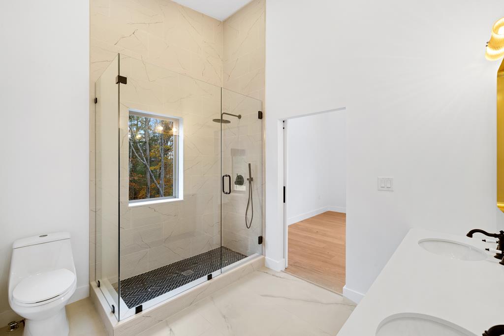 1713 Old Northcutt Road Ellijay, GA 30536 - Photo 38 of 45 a bathroom with a granite countertop sink toilet and shower