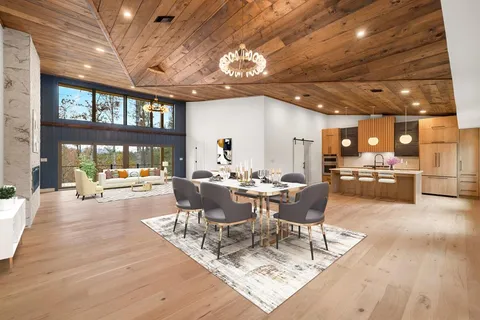 a view of house with a swimming pool and outdoor seating