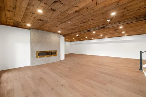 a view of an empty room with a fireplace