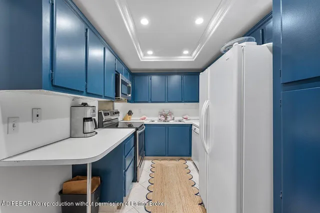 a kitchen with furniture a refrigerator and chairs