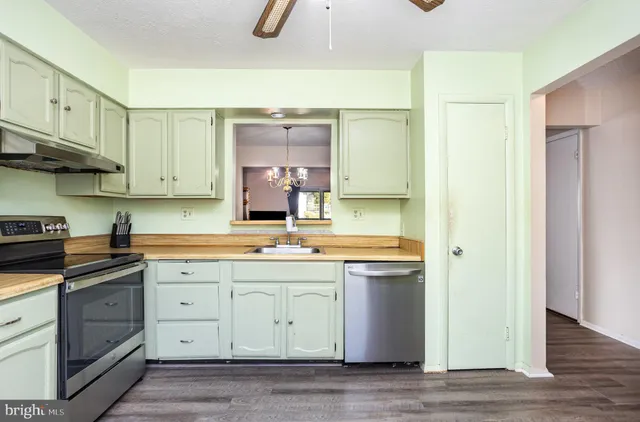a kitchen with a sink stove and cabinets