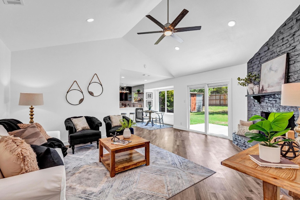 a living room with furniture potted plant and a large window