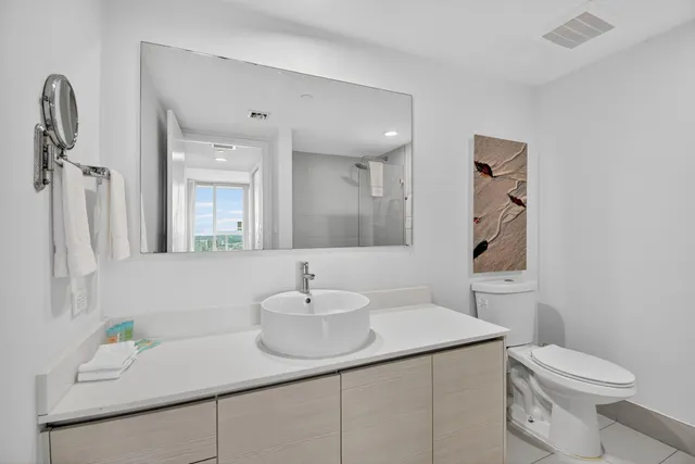 a view of a city from a balcony with furniture