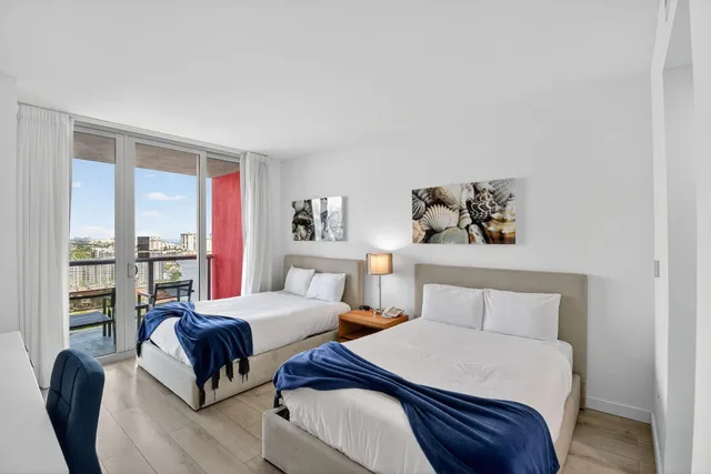 a view of a patio with table and chairs potted plants and palm tree