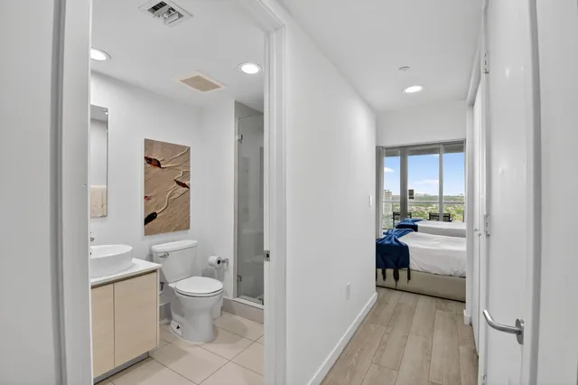 a room with wooden cabinets and stainless steel appliances