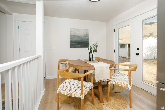 621 Timpie Road Tooele, UT 84074 - Photo 6 of 16 Dining area with light wood-finish flooring, white walls, and French doors leading to the exterior