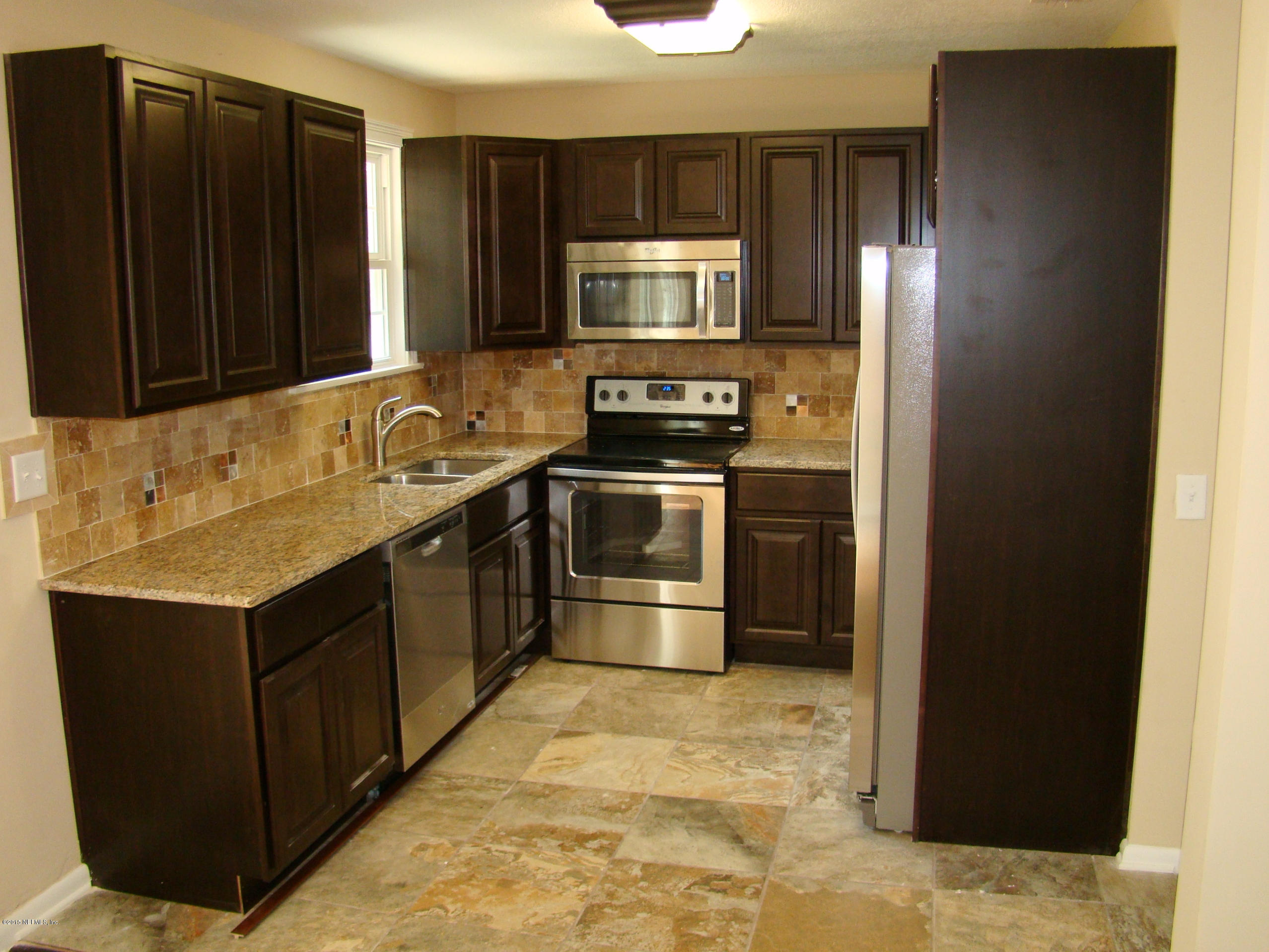 6315 Temple Road Jacksonville, FL 32217 - Photo 3 of 12 a kitchen with stainless steel appliances granite countertop a refrigerator and a sink