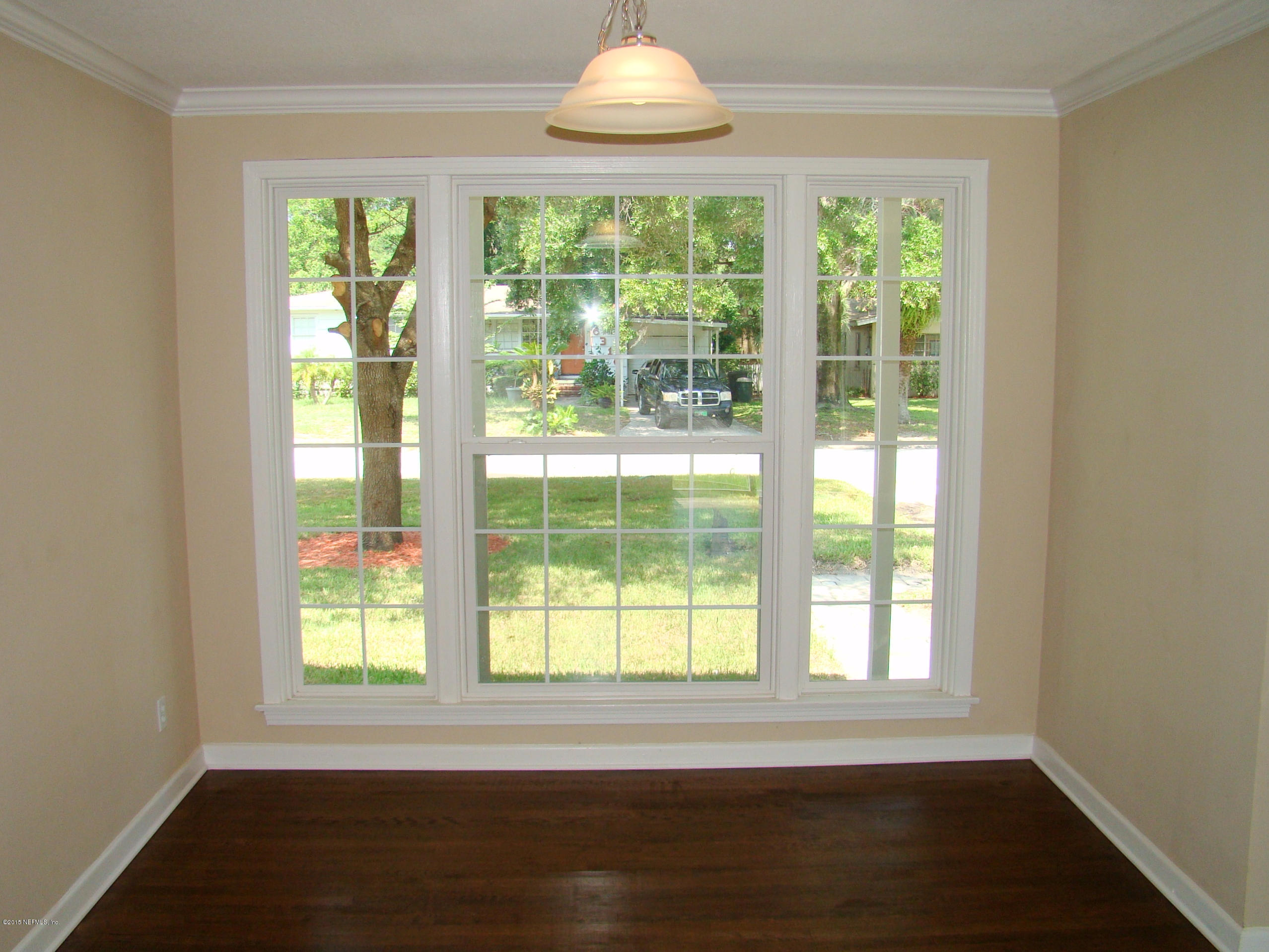 6315 Temple Road Jacksonville, FL 32217 - Photo 4 of 12 a view of an empty room with wooden floor and a window
