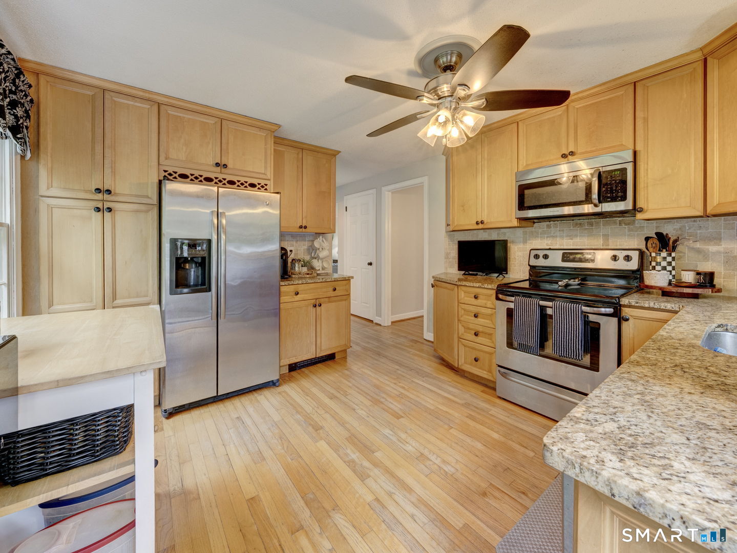 39 Freedom Drive Canton, CT 06019 - Photo 11 of 37 a kitchen with stainless steel appliances granite countertop a refrigerator a stove microwave and cabinets