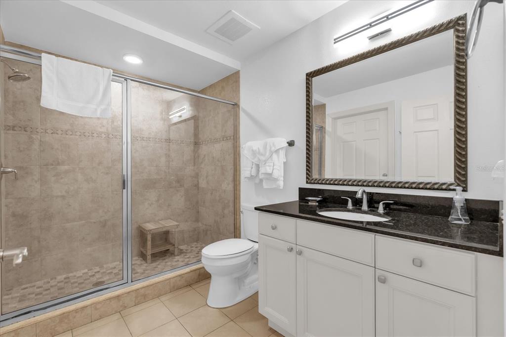 1362 Centre Ct Ridge Drive, Unit 102 Reunion, FL 34747 - Photo 18 of 35 a bathroom with a double vanity sink mirror and toilet