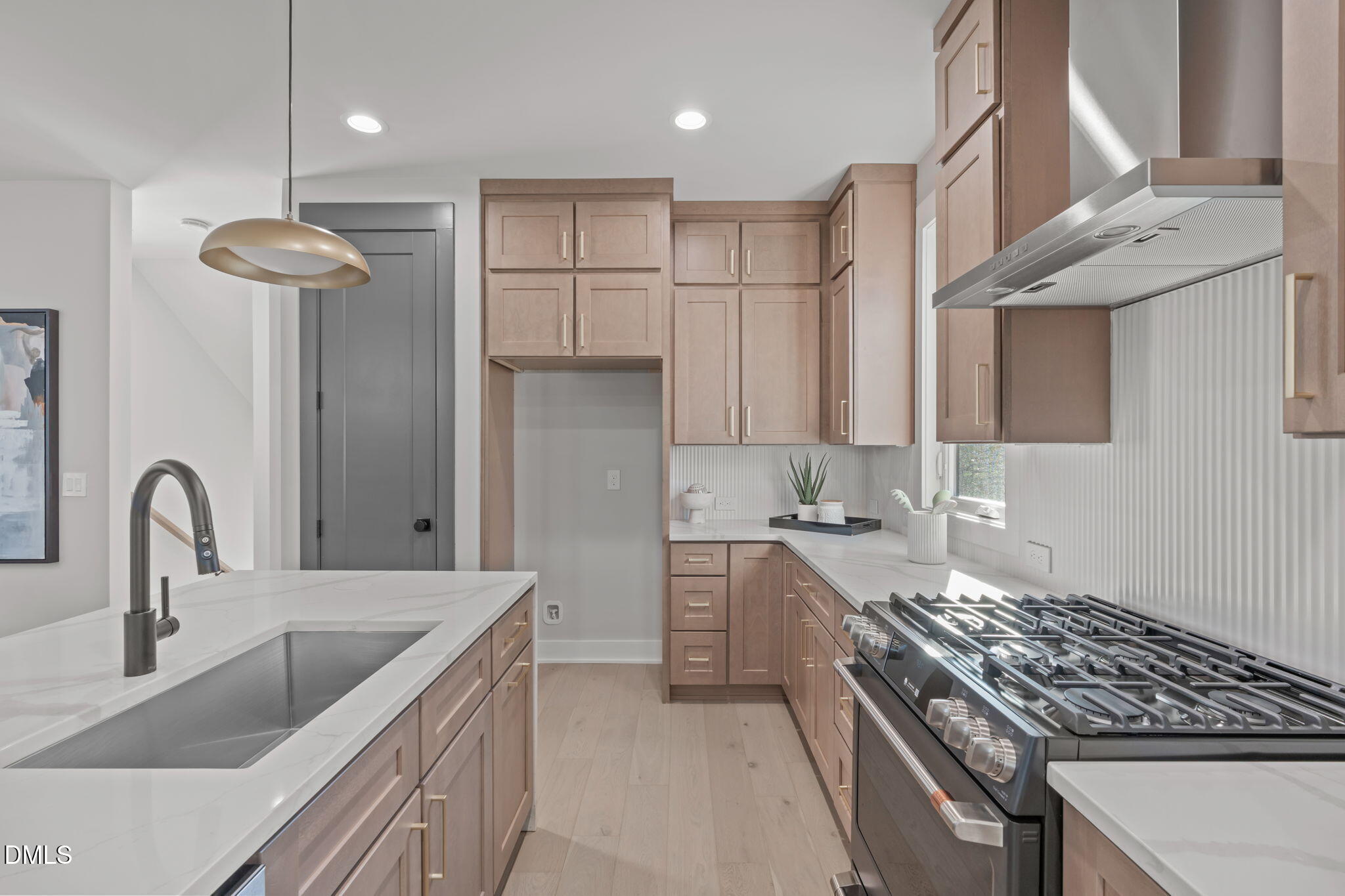 228 Woodsborough Place Raleigh, NC 27601 - Photo 10 of 59 a kitchen with stainless steel appliances granite countertop a sink a stove and a refrigerator