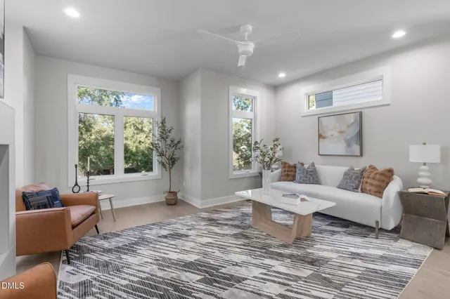 a living room with furniture fireplace and window