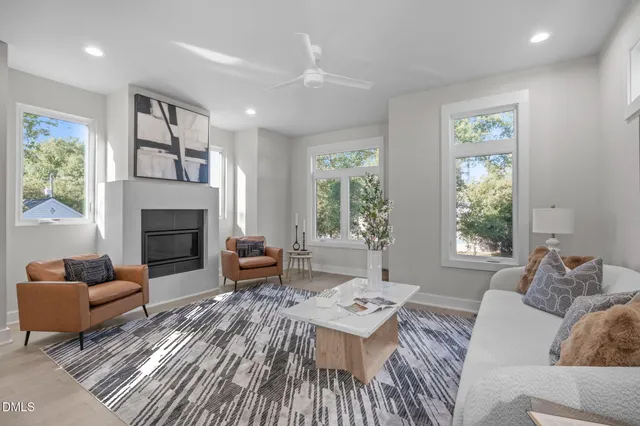 a living room with furniture and a wooden floor