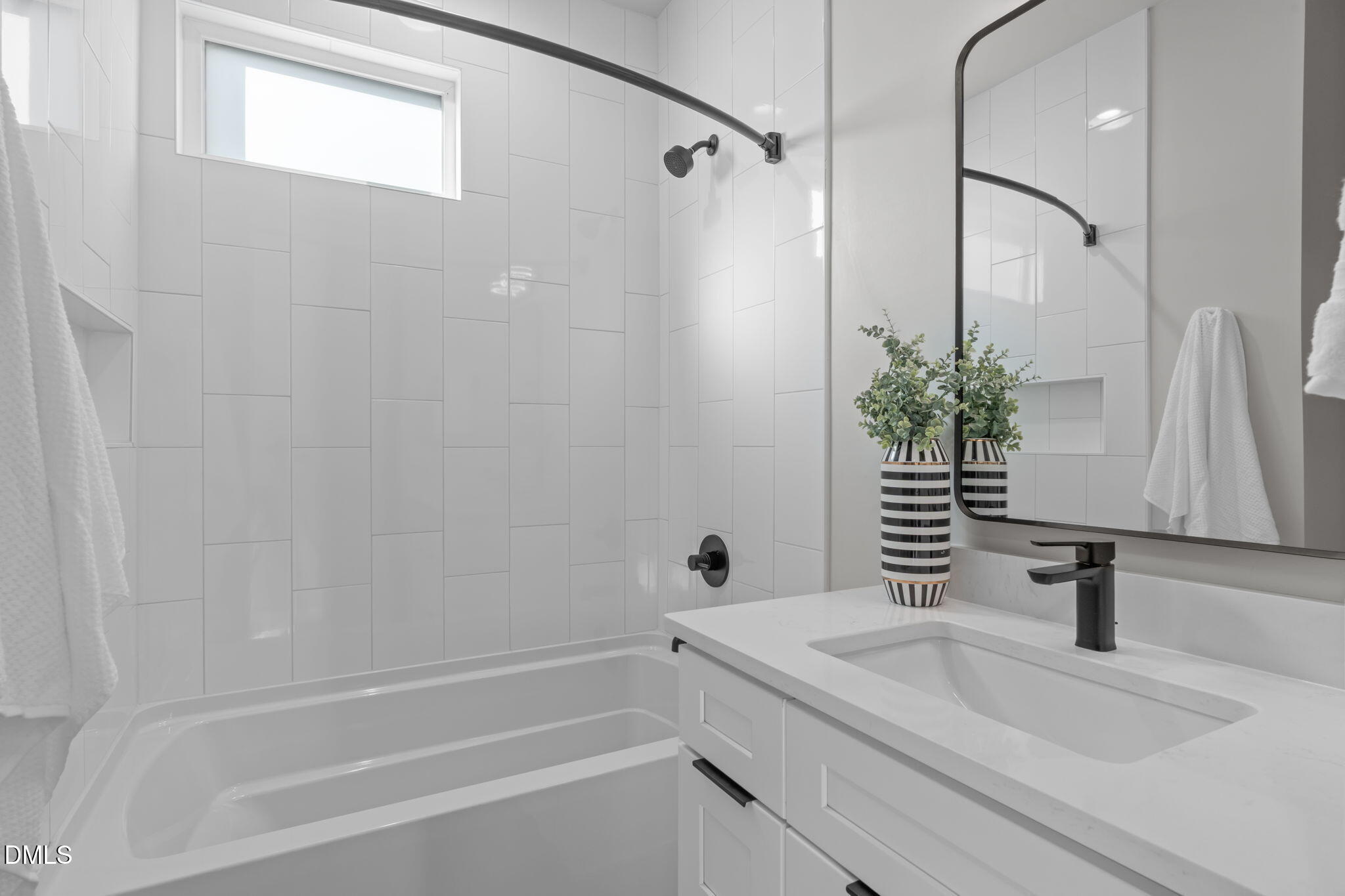 228 Woodsborough Place Raleigh, NC 27601 - Photo 16 of 59 a bathroom with a granite countertop sink and a mirror