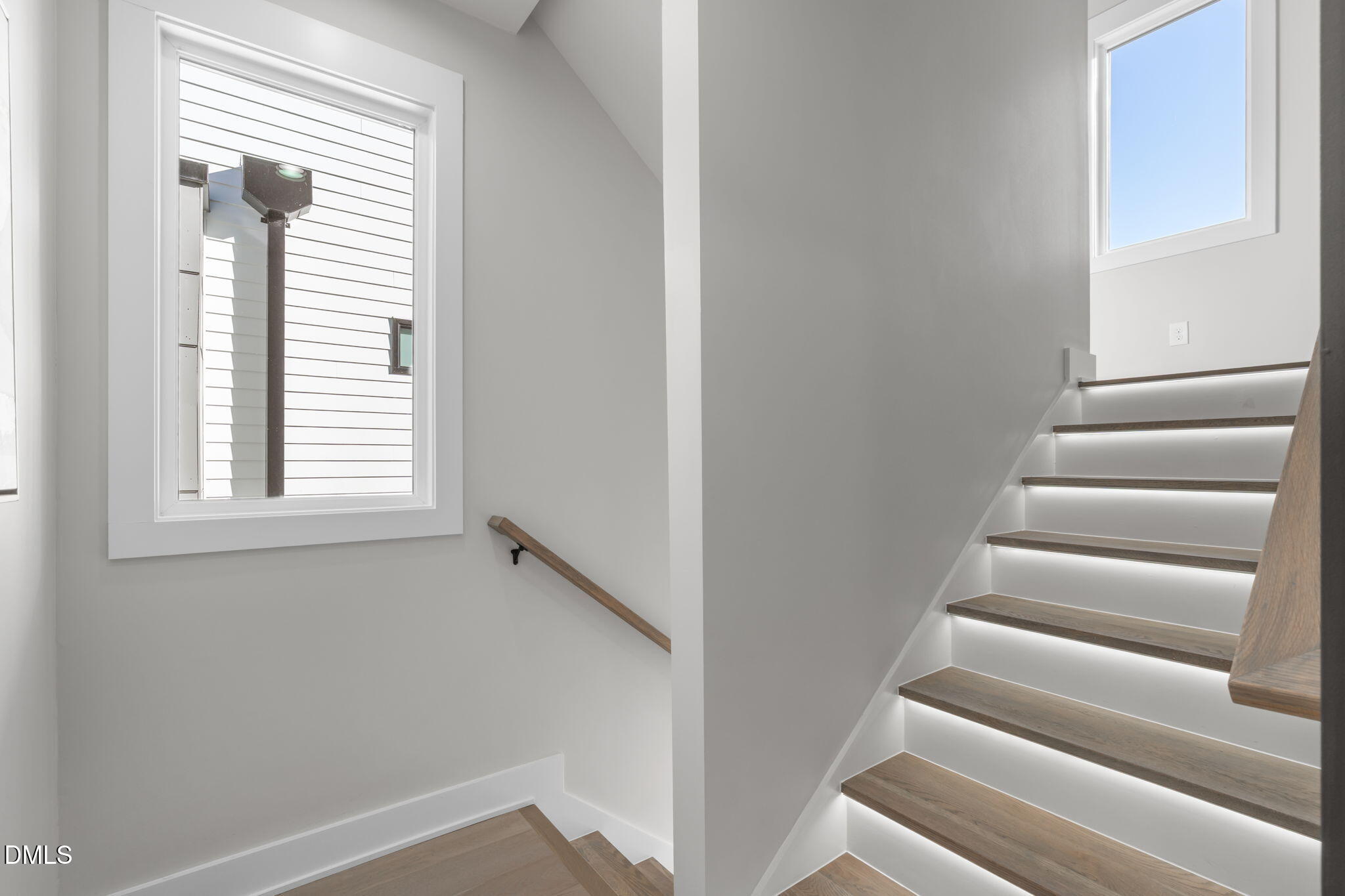 228 Woodsborough Place Raleigh, NC 27601 - Photo 18 of 59 a view of staircase with white walls and a window