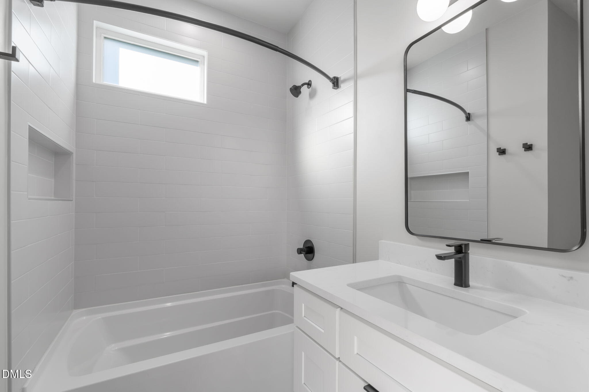 228 Woodsborough Place Raleigh, NC 27601 - Photo 21 of 59 a bathroom with a sink and a mirror