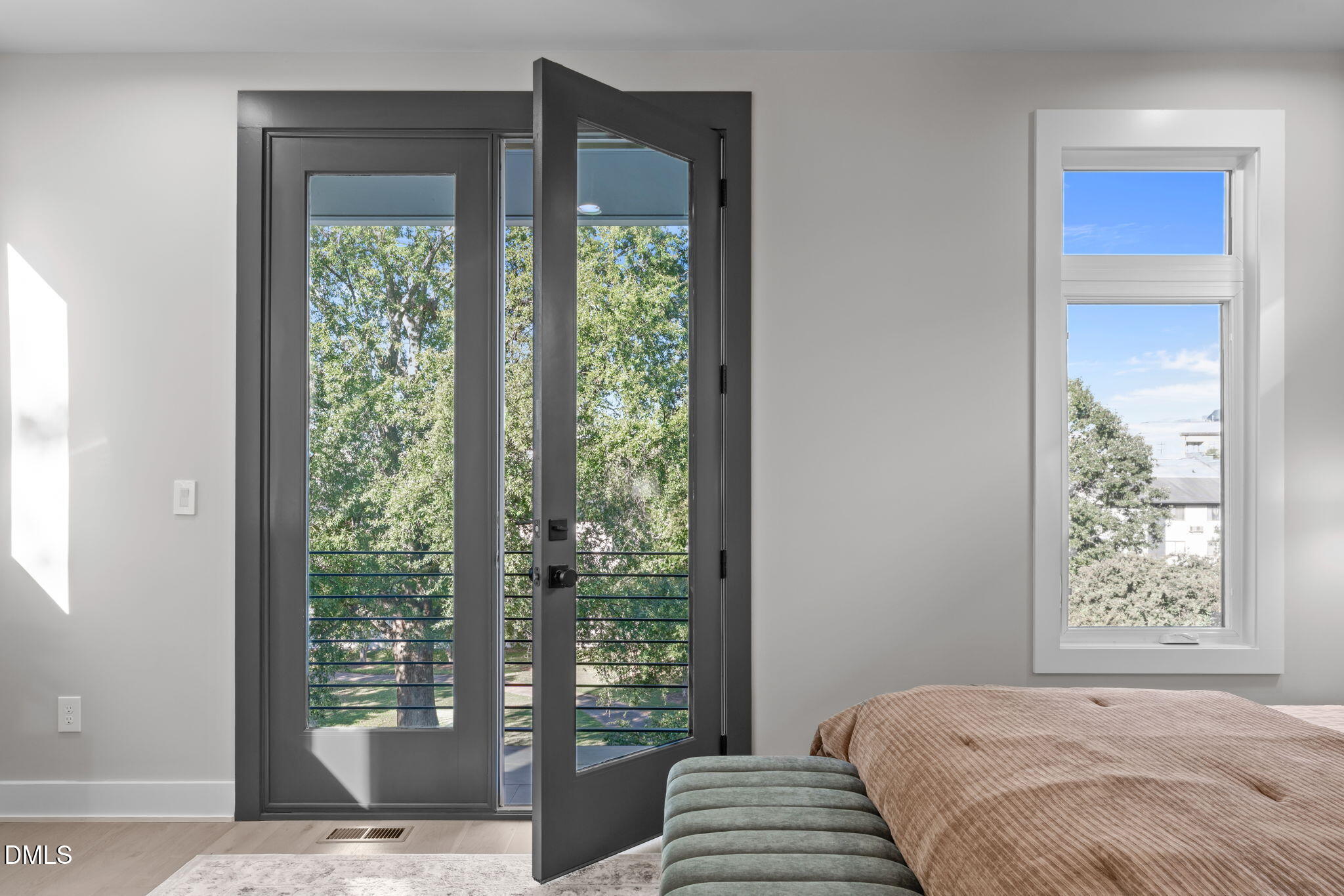 228 Woodsborough Place Raleigh, NC 27601 - Photo 28 of 59 a bedroom with a large window and a balcony