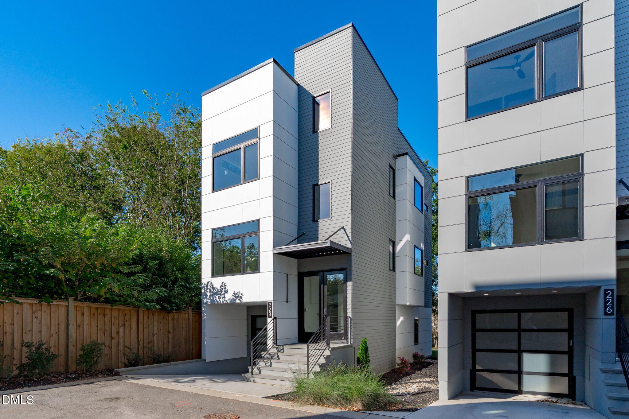 228 Woodsborough Place Raleigh, NC 27601 - Photo 2 of 59 a front view of a house with a garden
