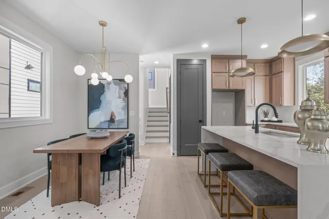 a kitchen with kitchen island a sink stove and refrigerator