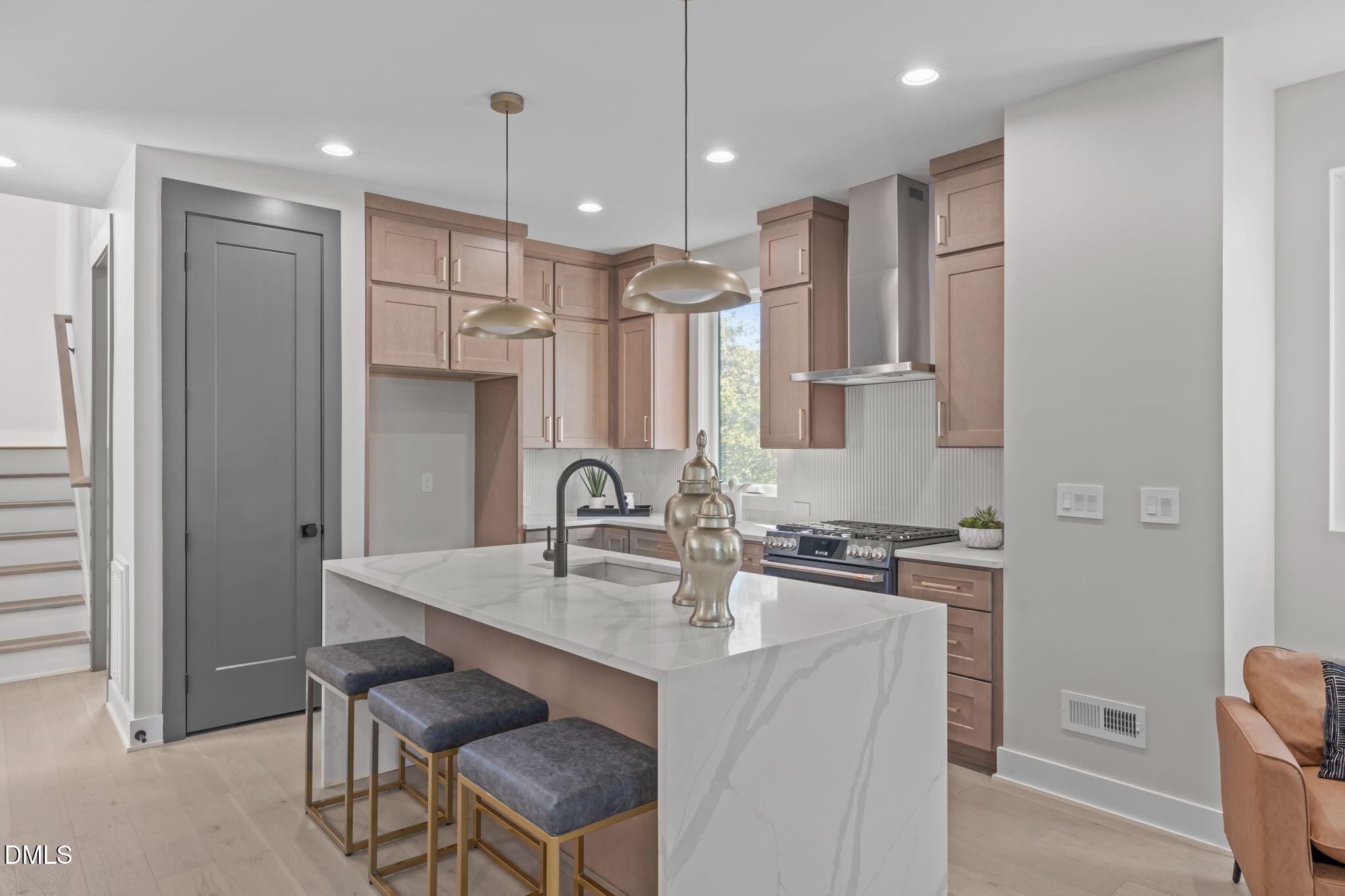228 Woodsborough Place Raleigh, NC 27601 - Photo 7 of 59 a kitchen with kitchen island a sink stove and refrigerator