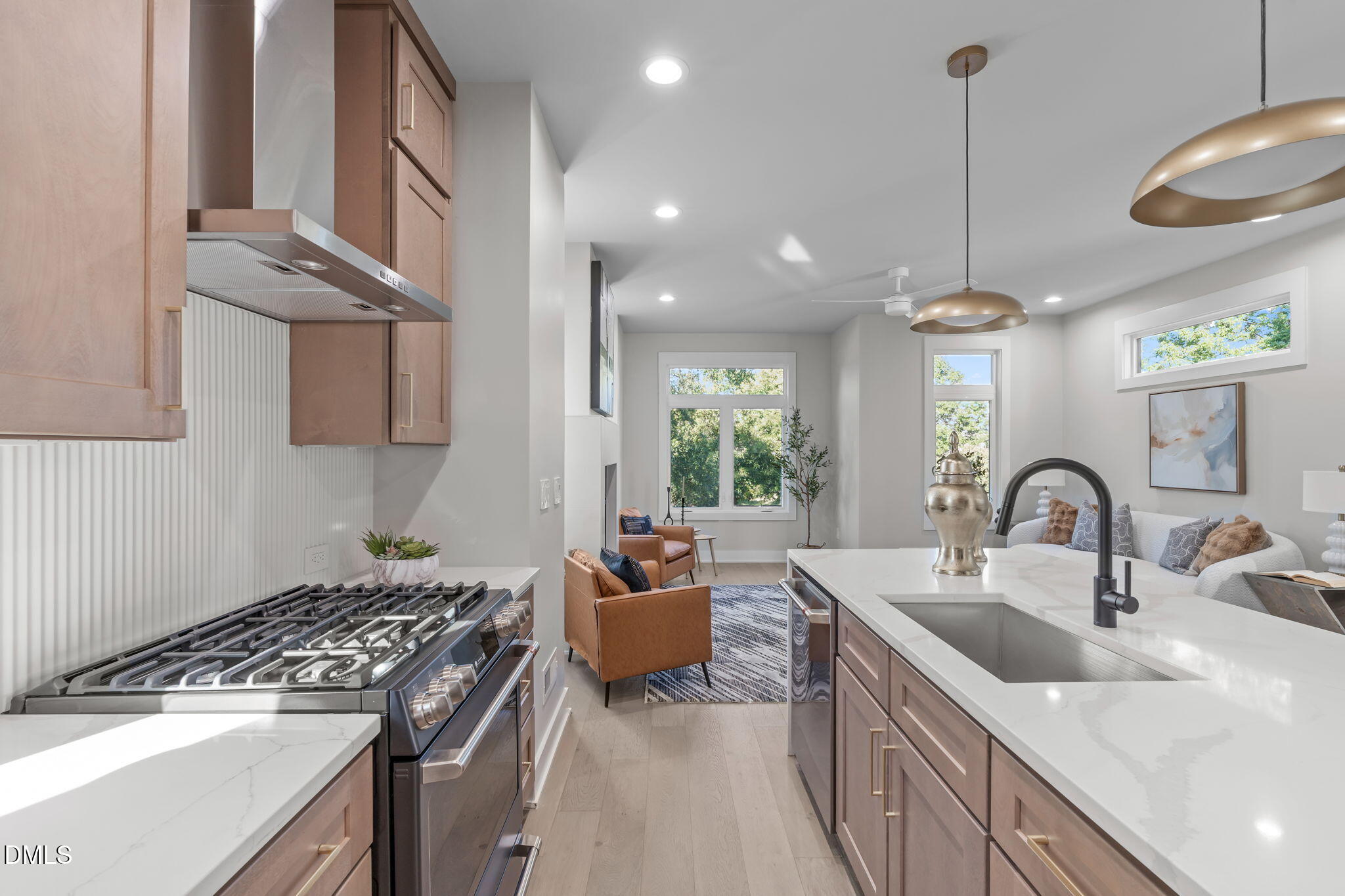 228 Woodsborough Place Raleigh, NC 27601 - Photo 9 of 59 a kitchen with stainless steel appliances granite countertop a sink a stove and a wooden floors