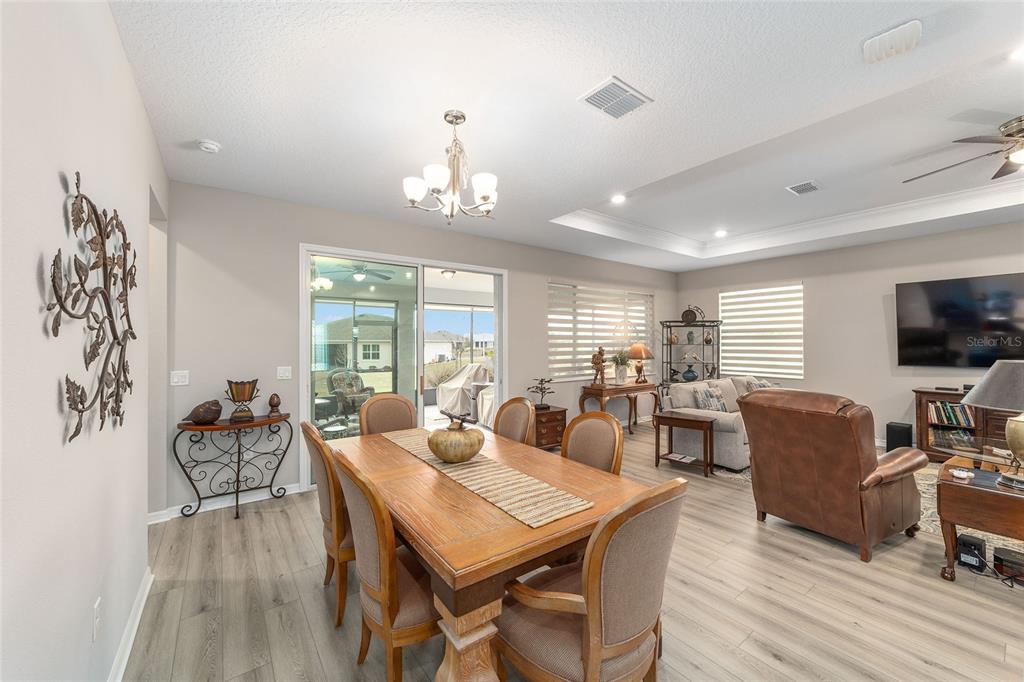10691 Southwest 99th Place Ocala, FL 34481 - Photo 12 of 52 a view of a dining room with furniture window and wooden floor