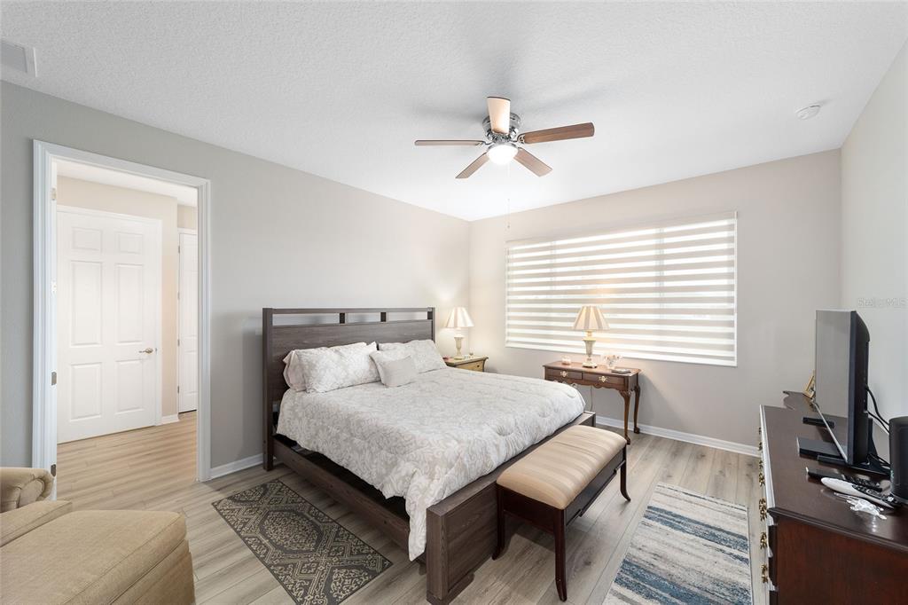 10691 Southwest 99th Place Ocala, FL 34481 - Photo 20 of 52 a bedroom with a bed and a flat screen tv