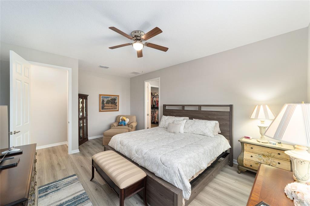 10691 Southwest 99th Place Ocala, FL 34481 - Photo 21 of 52 a bedroom with a bed and wooden floor