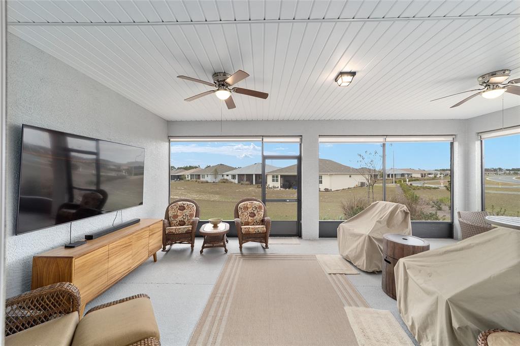 10691 Southwest 99th Place Ocala, FL 34481 - Photo 33 of 52 a living room with furniture and a flat screen tv