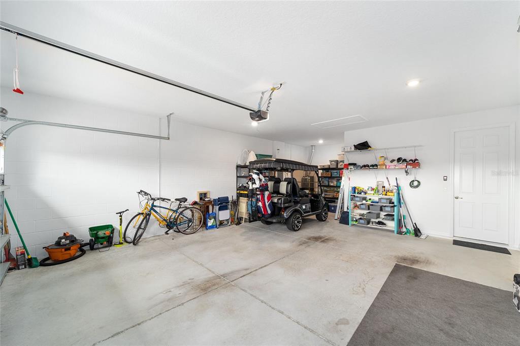 10691 Southwest 99th Place Ocala, FL 34481 - Photo 39 of 52 a view of a garage with a bike and car