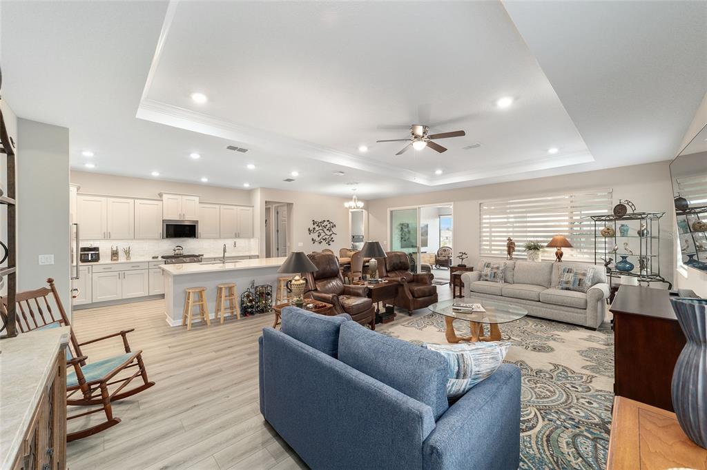10691 Southwest 99th Place Ocala, FL 34481 - Photo 6 of 52 a living room with furniture kitchen view and a wooden floor