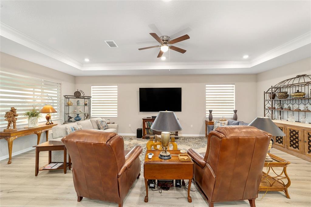 10691 Southwest 99th Place Ocala, FL 34481 - Photo 8 of 52 a living room with furniture a flat screen tv and a large window
