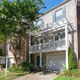 a front view of a house with a garden and plants