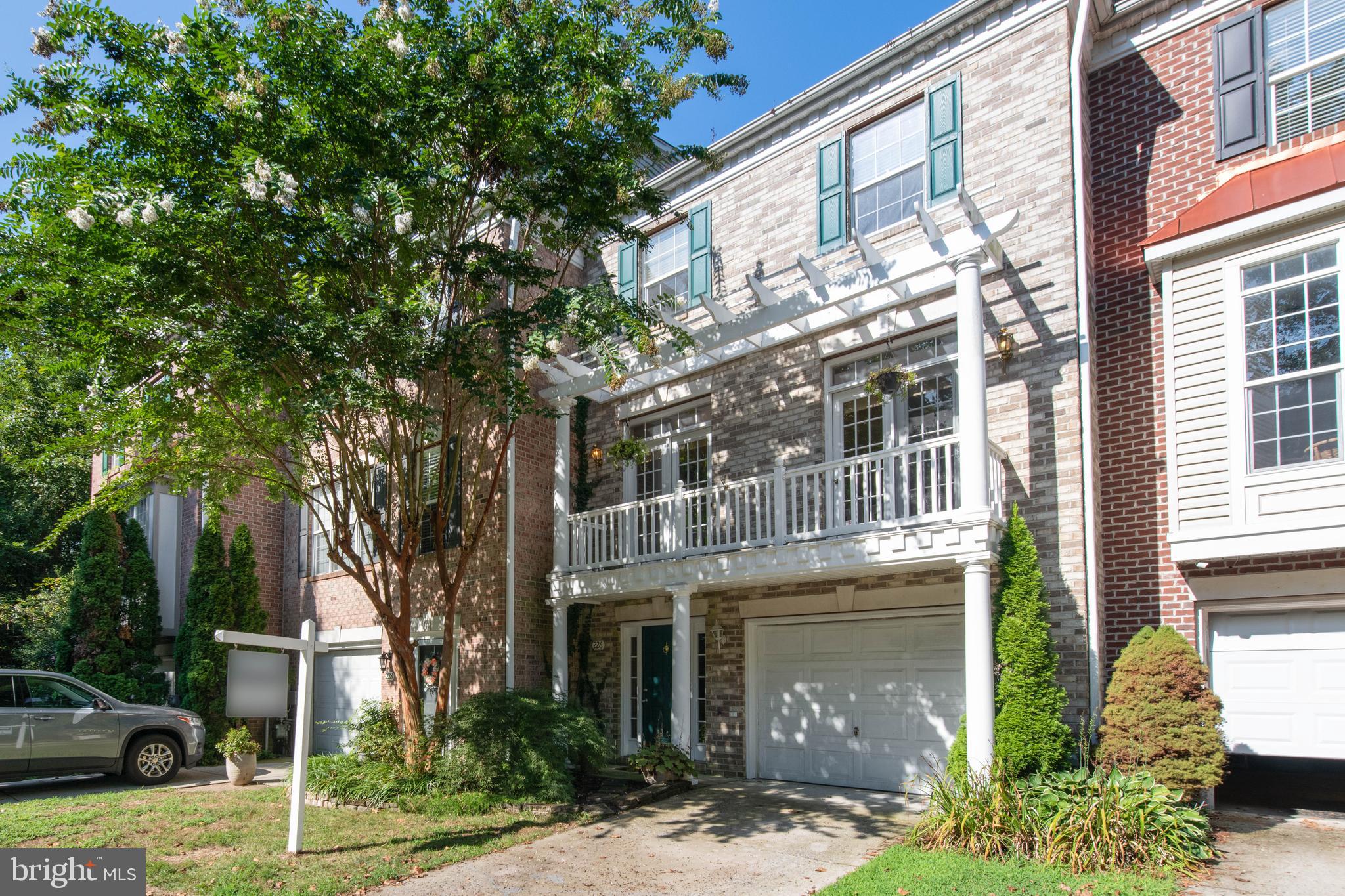 a front view of a house with a garden and plants