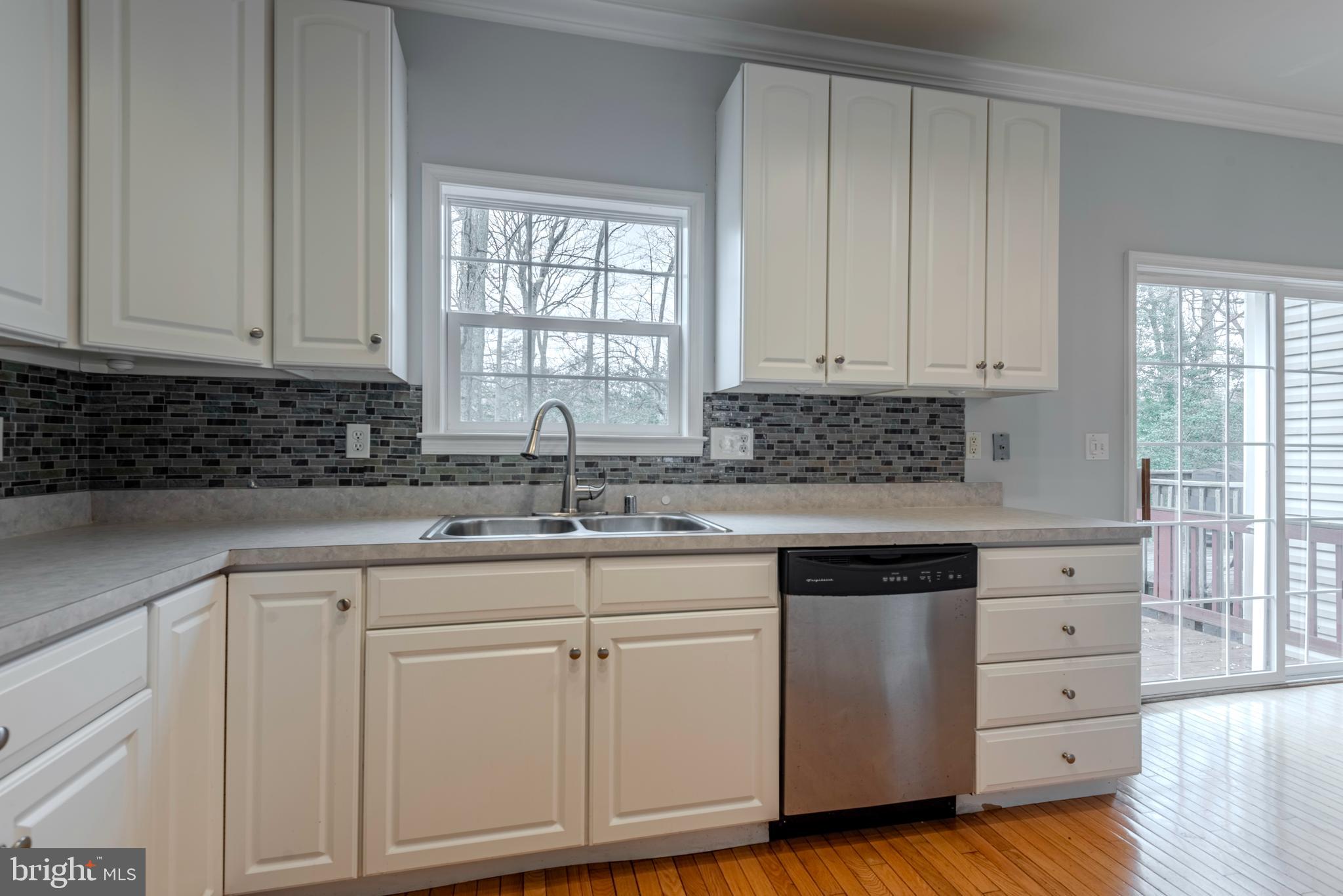 226 Wintergull Lane Annapolis, MD 21409 - Photo 14 of 38 a kitchen with white cabinets and sink