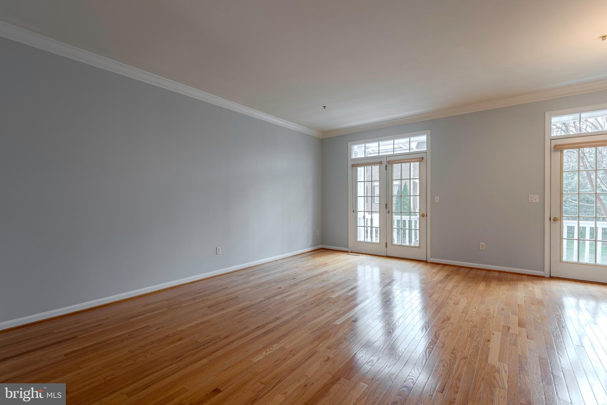 226 Wintergull Lane Annapolis, MD 21409 - Photo 17 of 38 a view of an empty room with wooden floor and a window