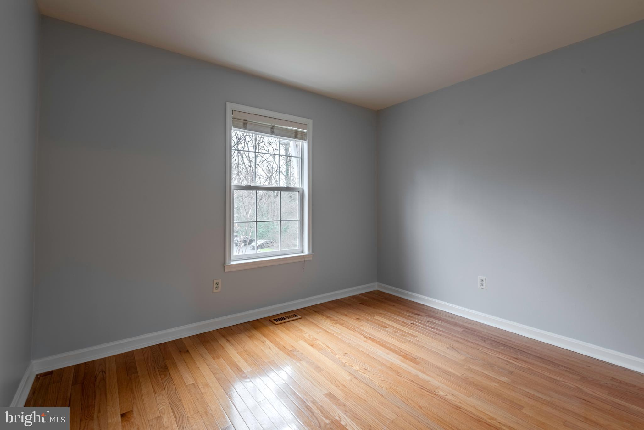 226 Wintergull Lane Annapolis, MD 21409 - Photo 25 of 38 an empty room with wooden floor and windows