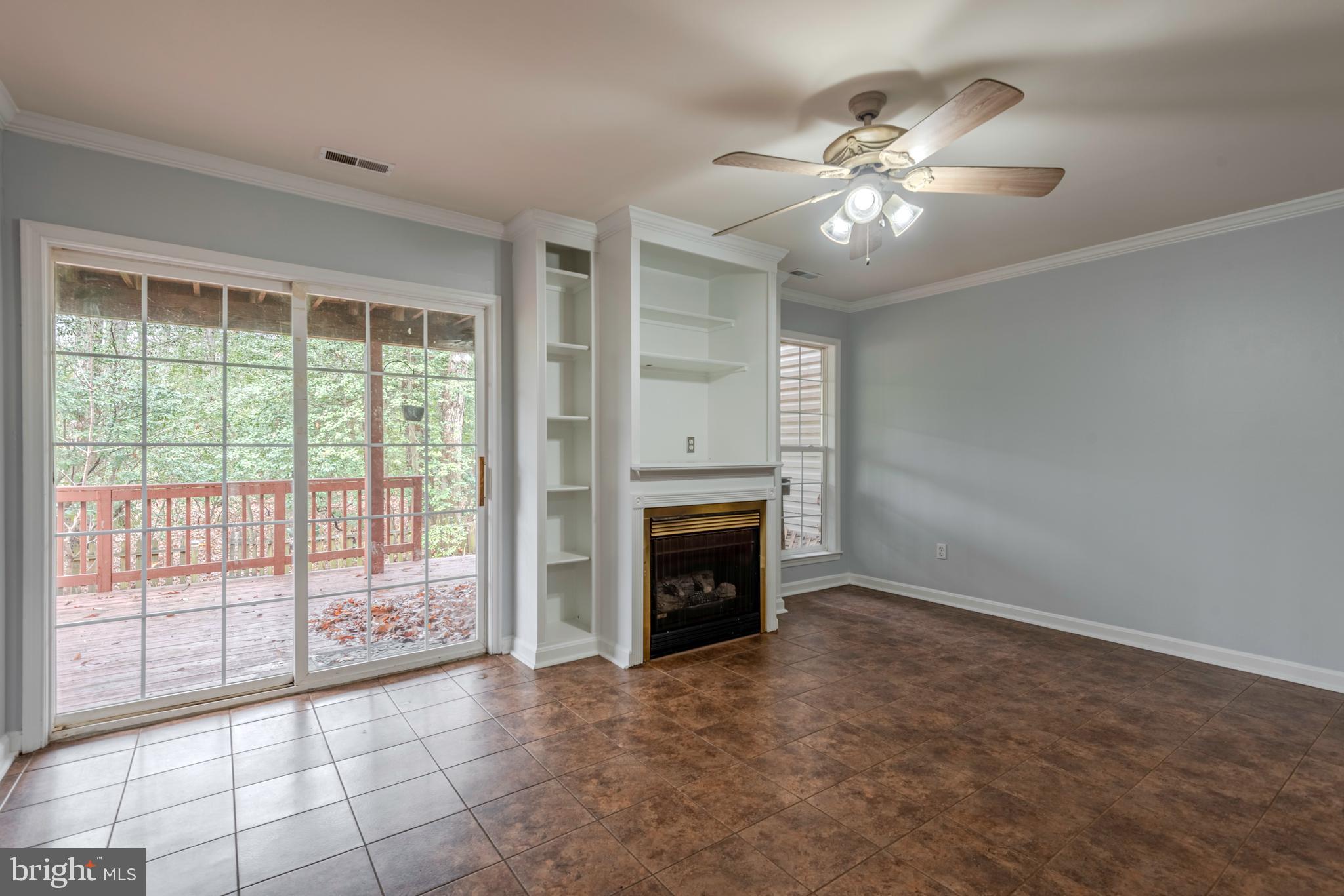 226 Wintergull Lane Annapolis, MD 21409 - Photo 7 of 38 a view of an empty room with chandelier fan and fire place