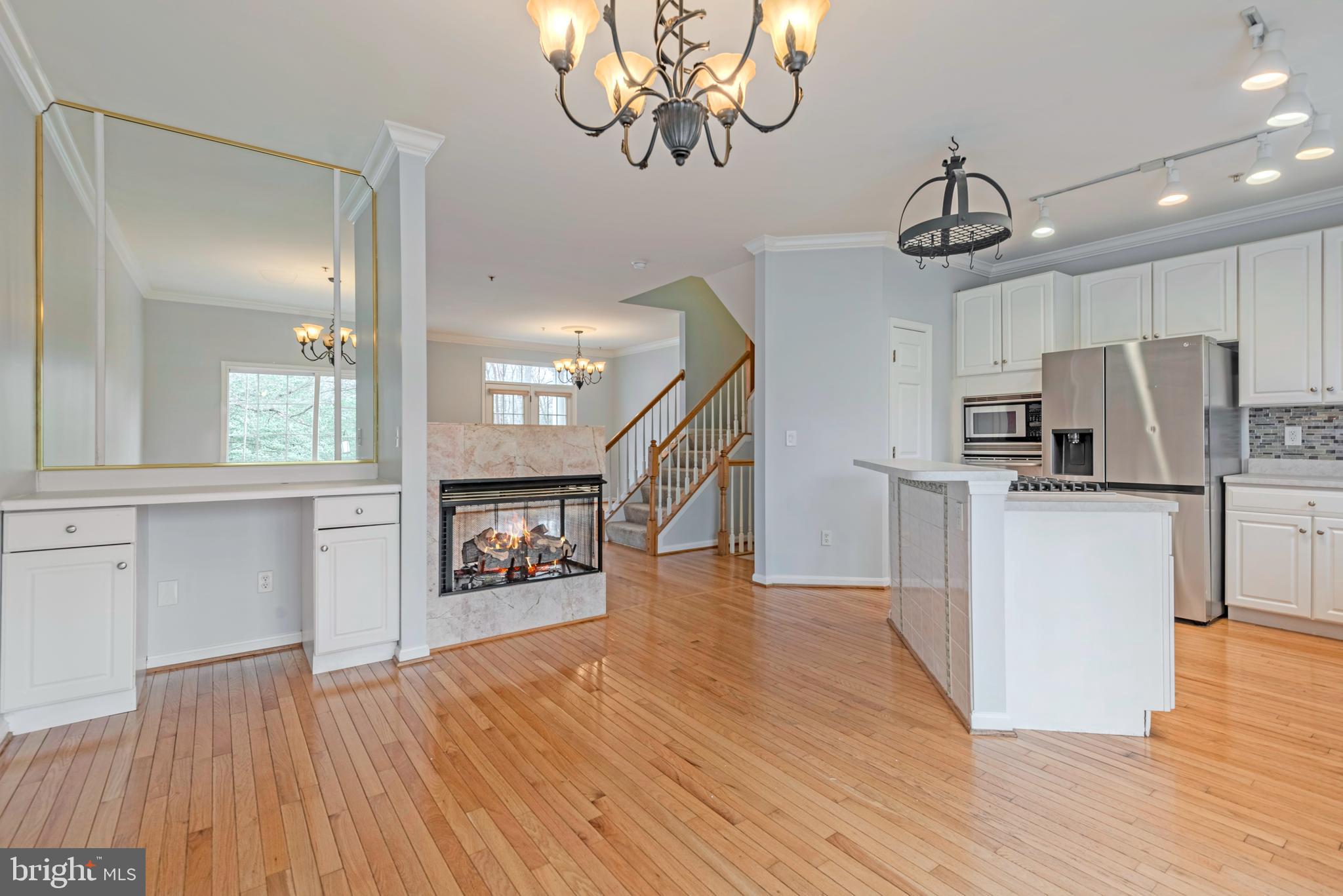 226 Wintergull Lane Annapolis, MD 21409 - Photo 9 of 38 a view of a kitchen with a wooden floor and a refrigerator