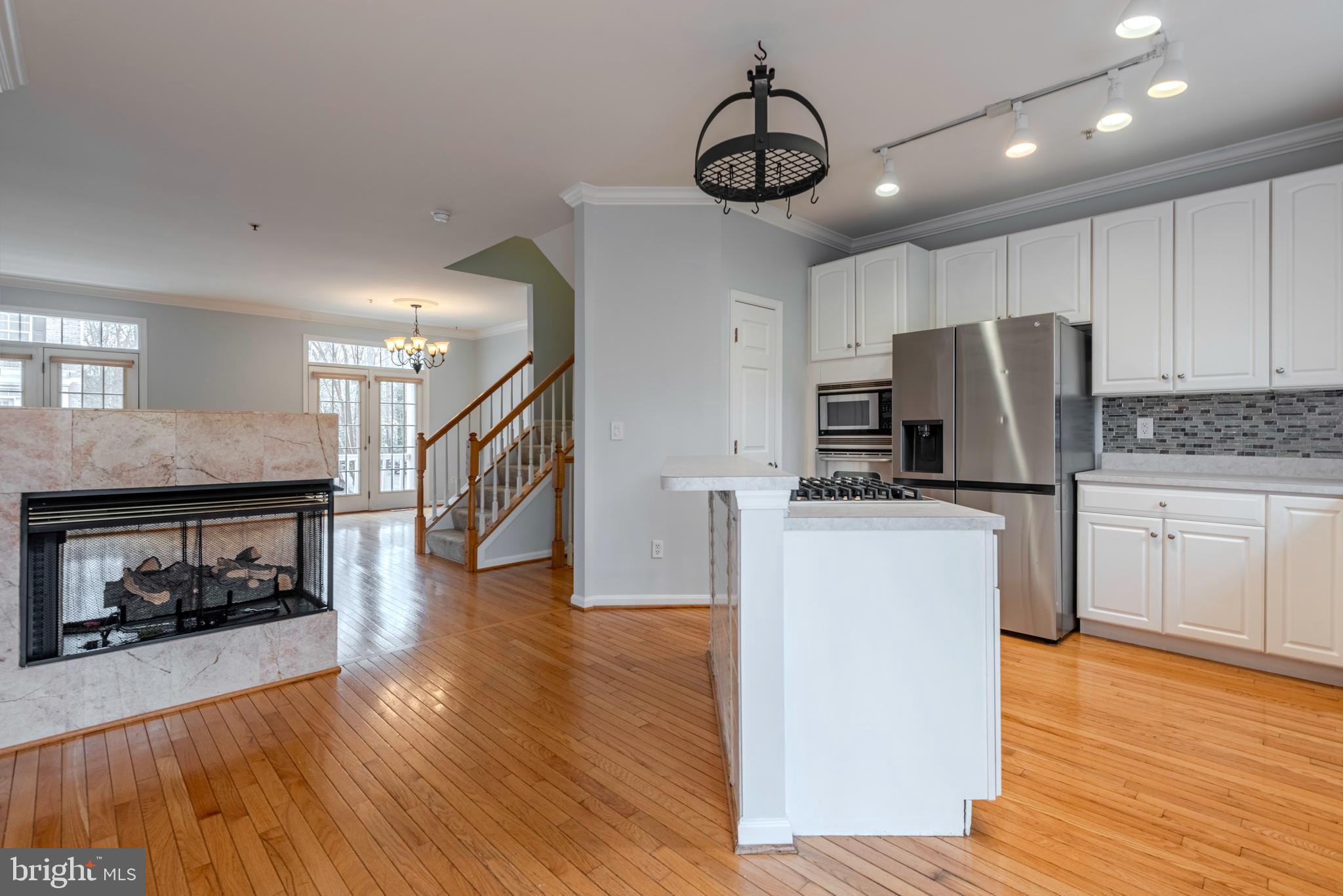 226 Wintergull Lane Annapolis, MD 21409 - Photo 10 of 38 a kitchen with kitchen island a counter top space stainless steel appliances and wooden floor