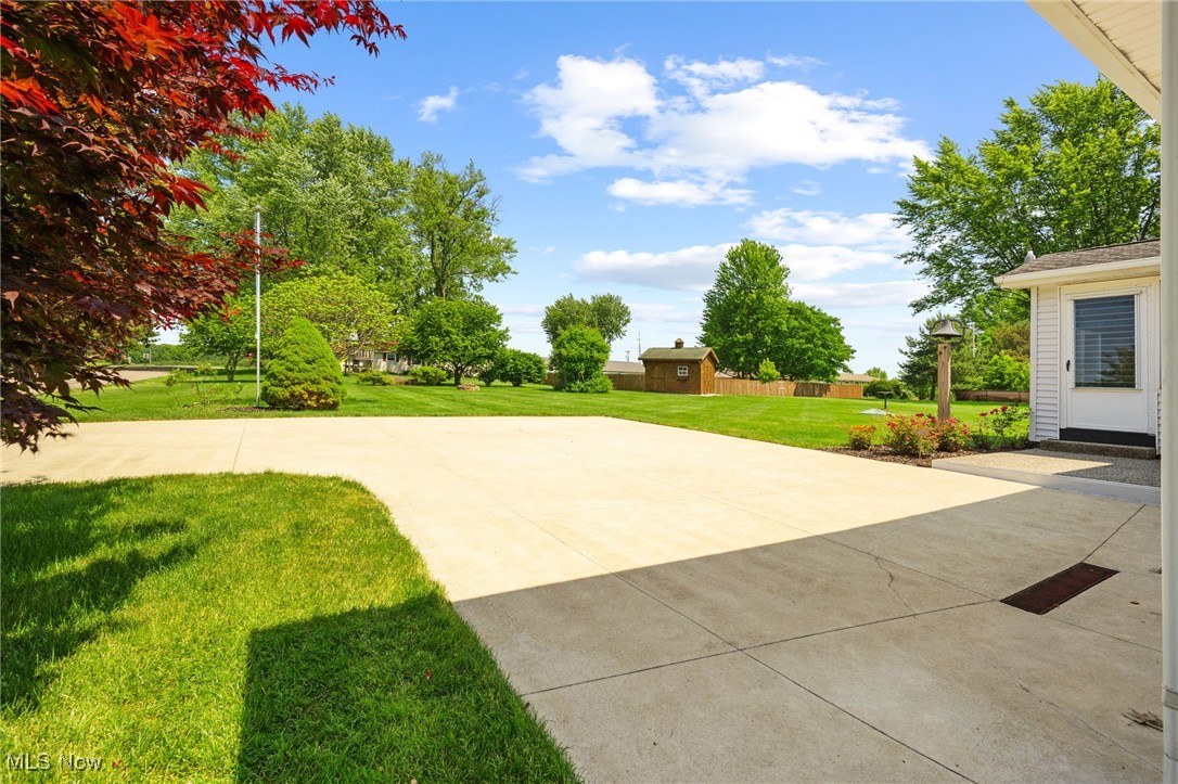 6944 Rolling Ridge Road Northeast Canton, OH 44721 - Photo 23 of 27 View of green lawn with a shed and a patio